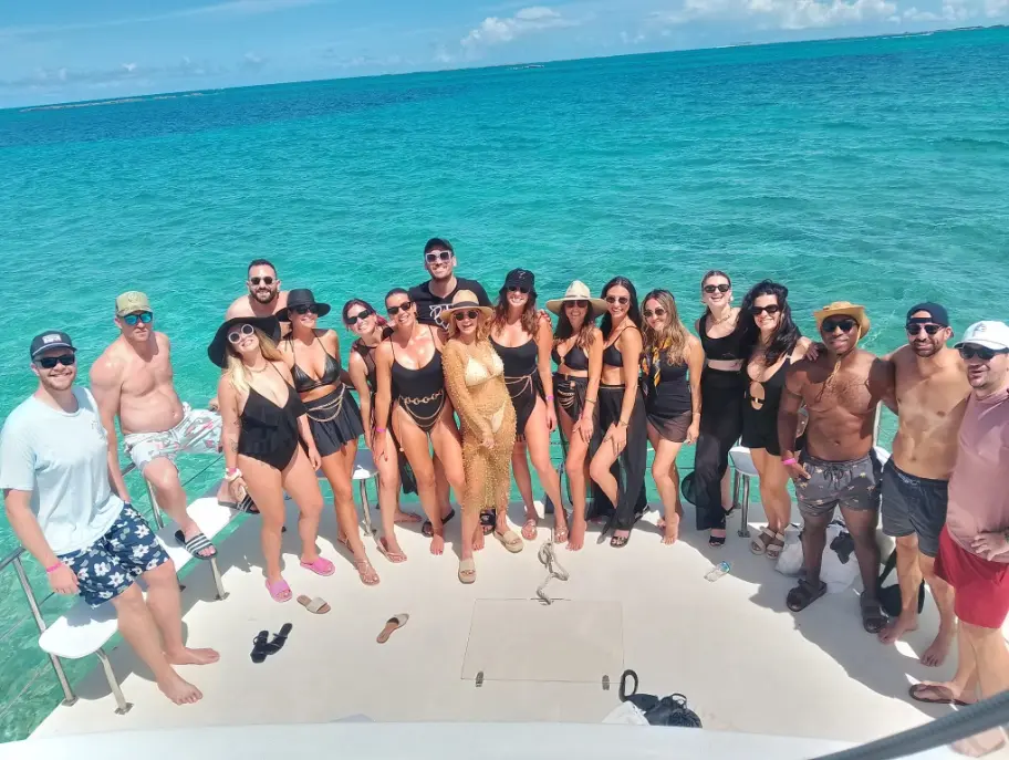 Large group of guests gathered on the deck of a Seas N' Cays catamaran in Nassau