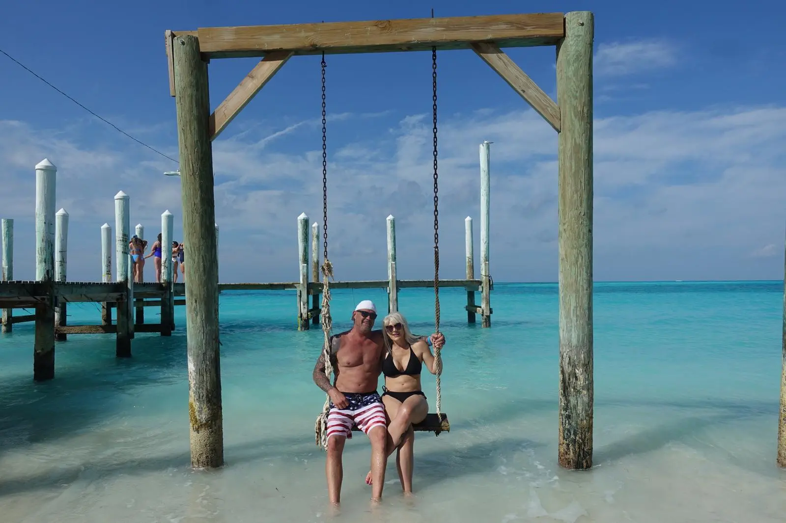 Guests relaxing in the shallow turquoise water off the Rose Island beach, Bahamas
