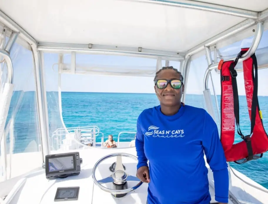 Seas N' Cays crew member on the catamaran deck during a Rose Island tour