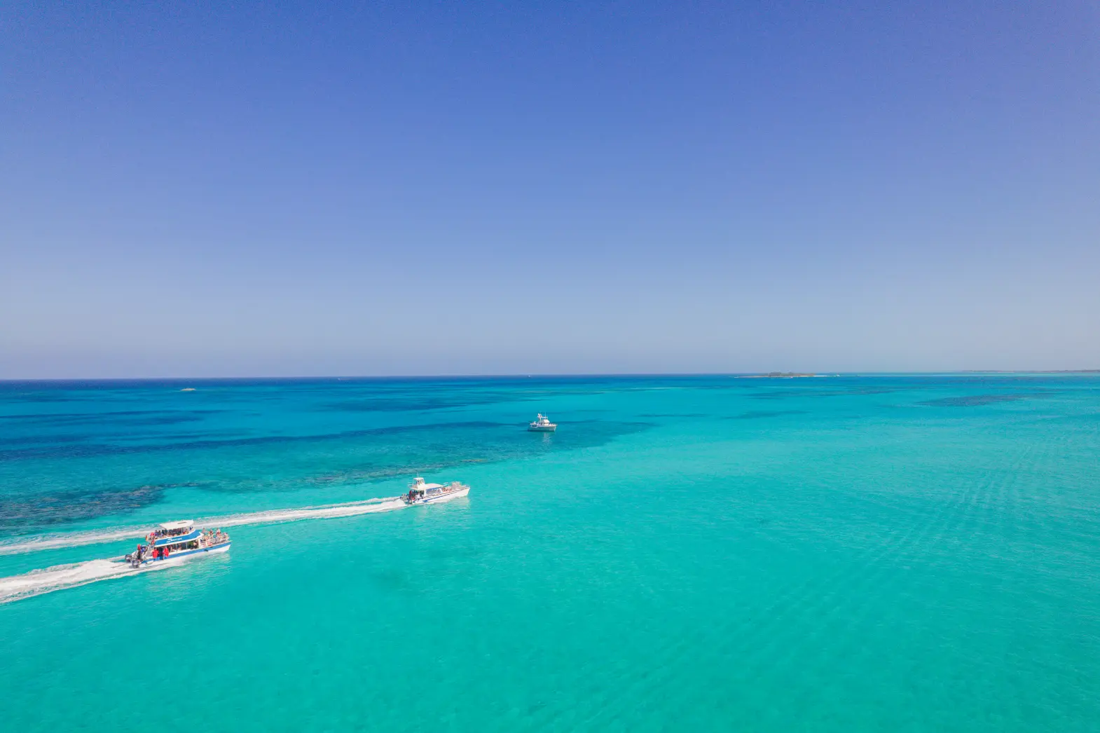 Aerial view of the Seas N' Cays catamaran on brilliant blue Bahamian water