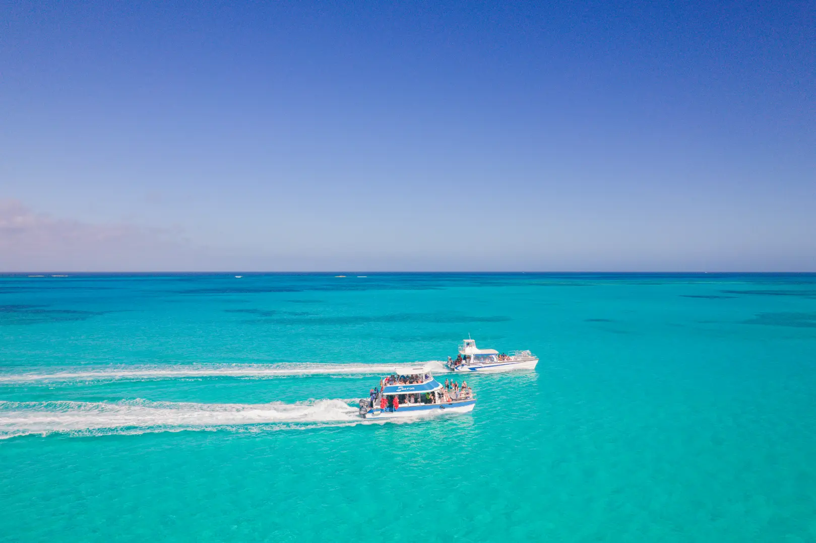Aerial view of a Seas N' Cays catamaran anchored off a quiet Bahamian beach