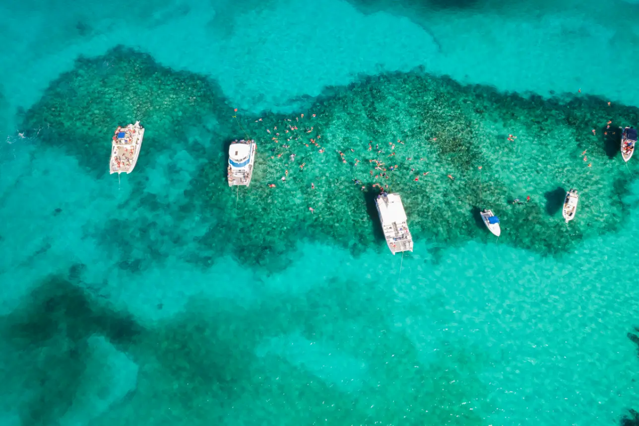 Seas N' Cays catamaran moored in clear shallow water near Rose Island