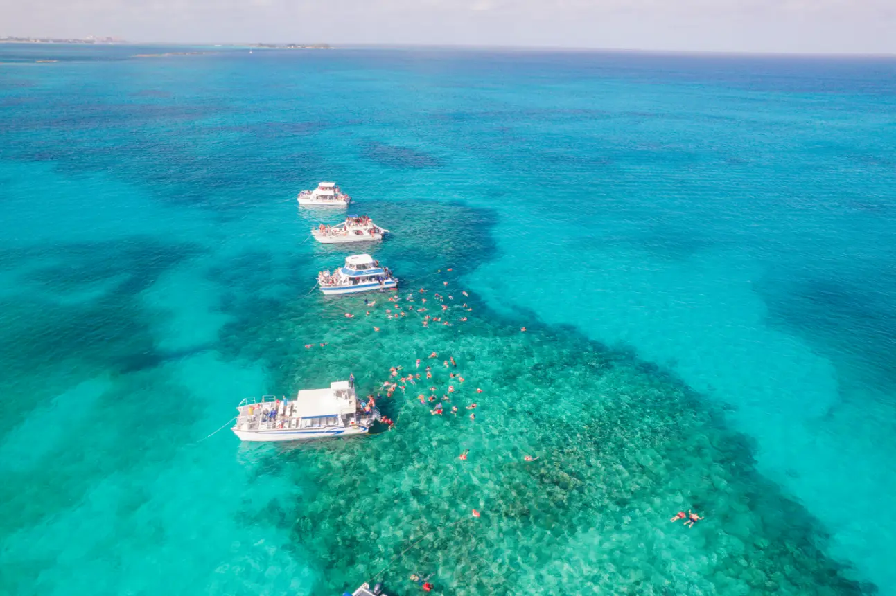 Seas N' Cays catamaran anchored over brilliant turquoise water near Rose Island, Nassau